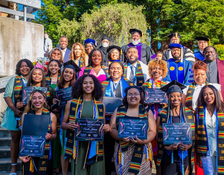 A group of black graduates in blue Cap and Gowns