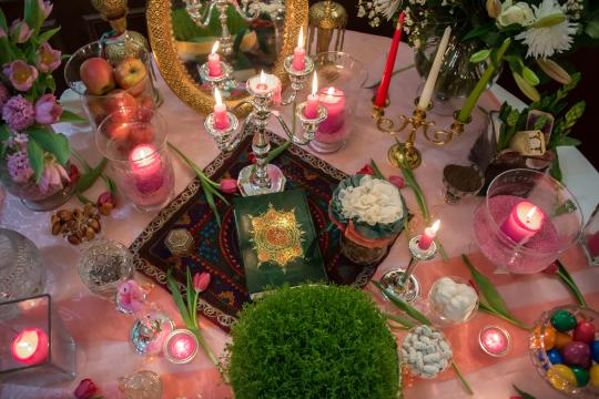 A vibrant Haft-Seen table set for Nowruz, featuring symbolic items.