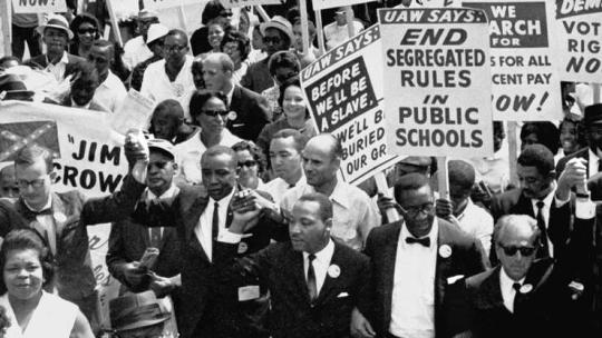 Grayscale photo of civil rights supporters protesting holding up signs