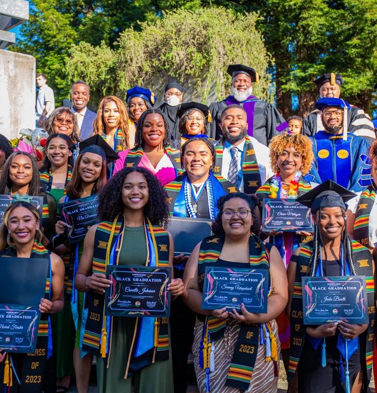 A group of black graduates in blue Cap and Gowns